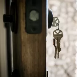 New keys made by Brady's Locksmith dangle from a front door deadbolt lock